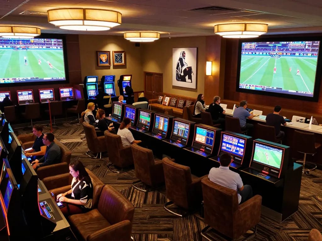 Guests engaging in exciting sports betting activities at 11bet lounge with live screens